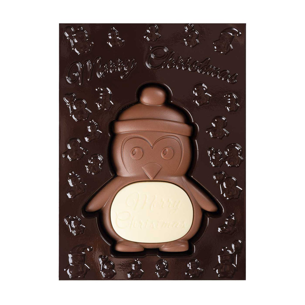 Chocolade pinguïn in een donkere doos met sterren