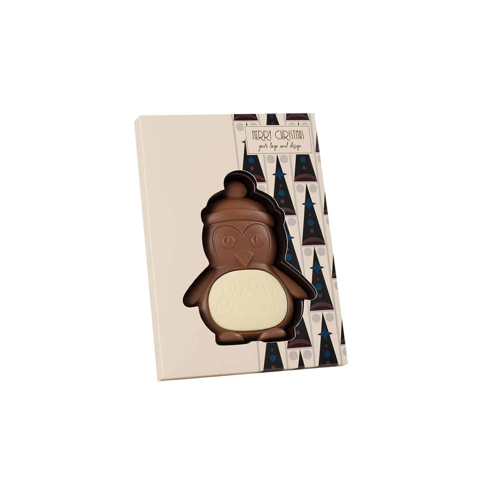 Chocolade pinguïn in een doos met kerstboompatroon