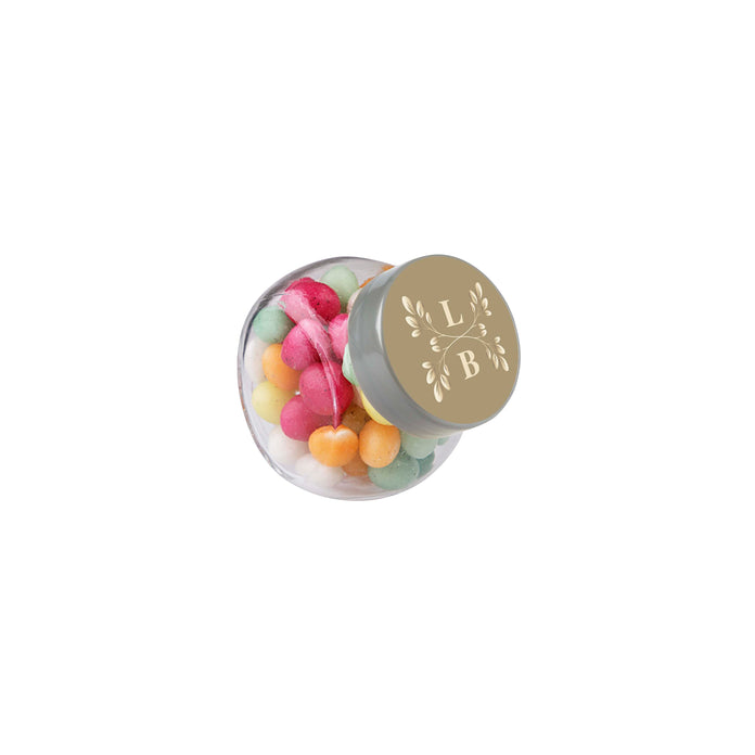 Micro glazen potje van 50 ml gevuld met snoep en ronde sticker met logo op het deksel: Gekleurde Suikereitjes