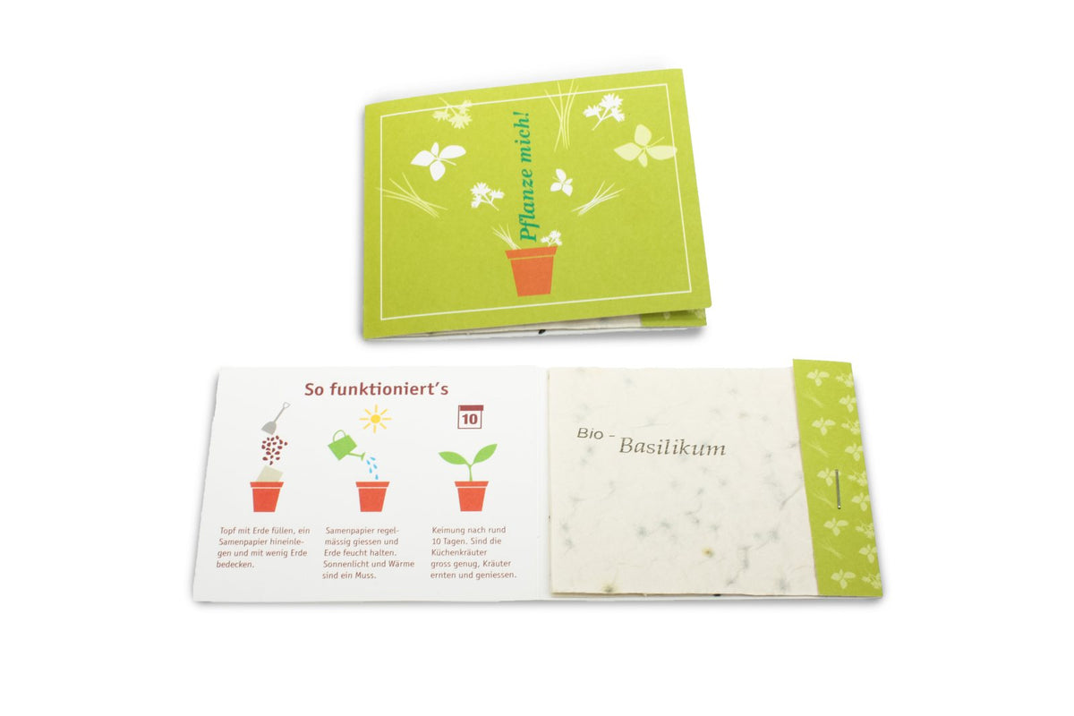 Kaart met een vel zaadpapier en uitleg aan de binnenkant, naast een gesloten bedrukte kaart