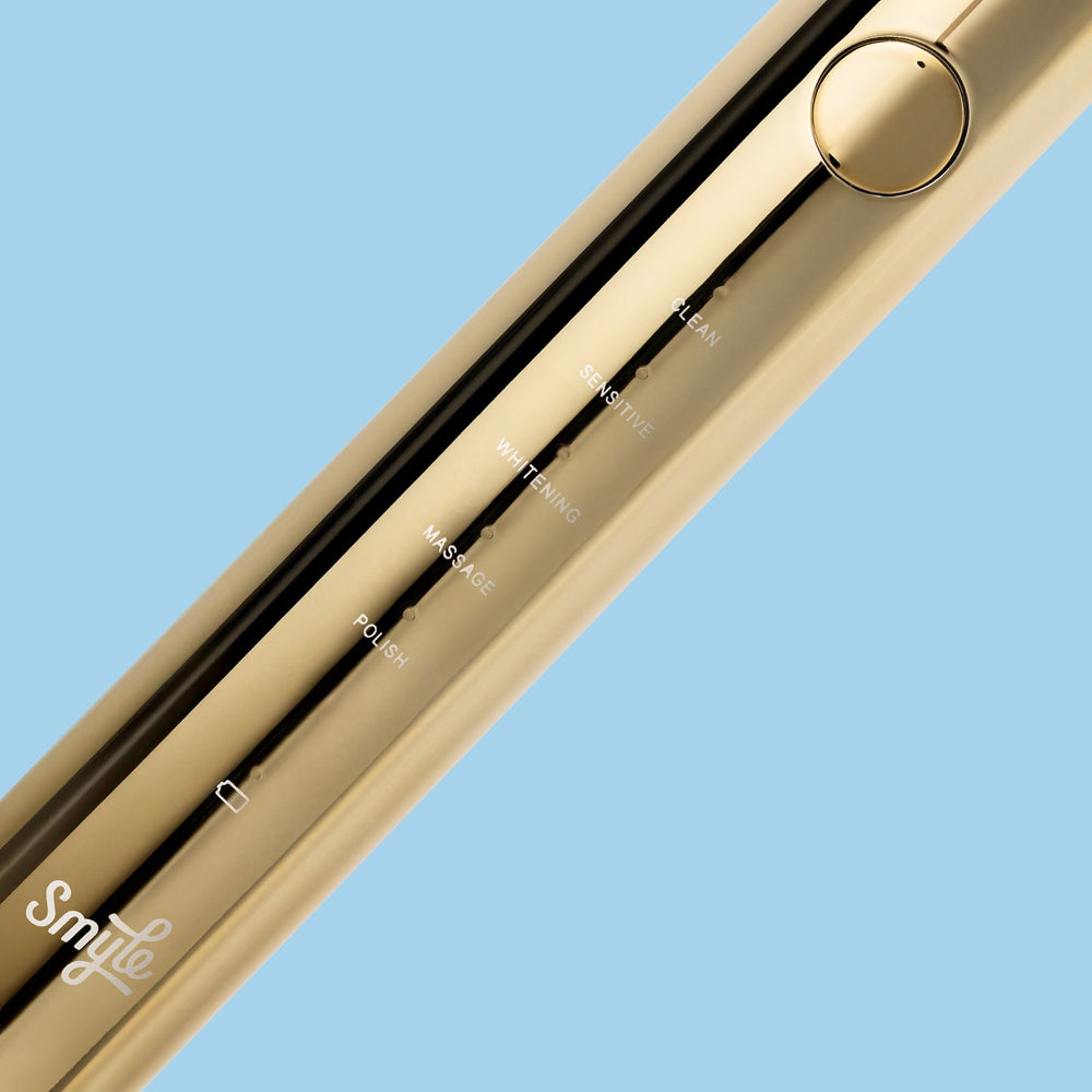 Close-up van de gouden Smyle elektrische tandenborstel